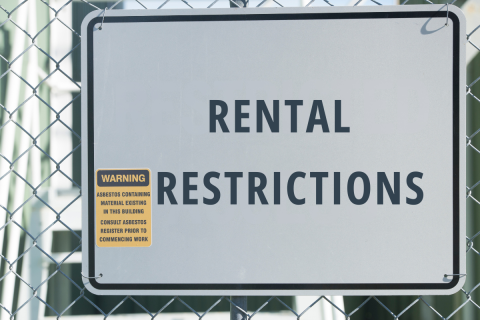 Rental restrictions checklist with house model, keys, and fair housing materials for tenant rules