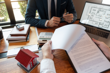 Tampa Bay rental property owner reviewing management reports with a property manager outside a well-maintained home