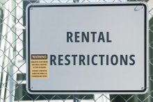 Rental restrictions checklist with house model, keys, and fair housing materials for tenant rules